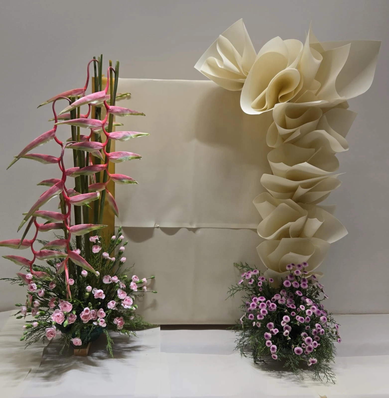 A dried-leaf screen with bird of paradise, chrysanthemum and trailing amaranthus